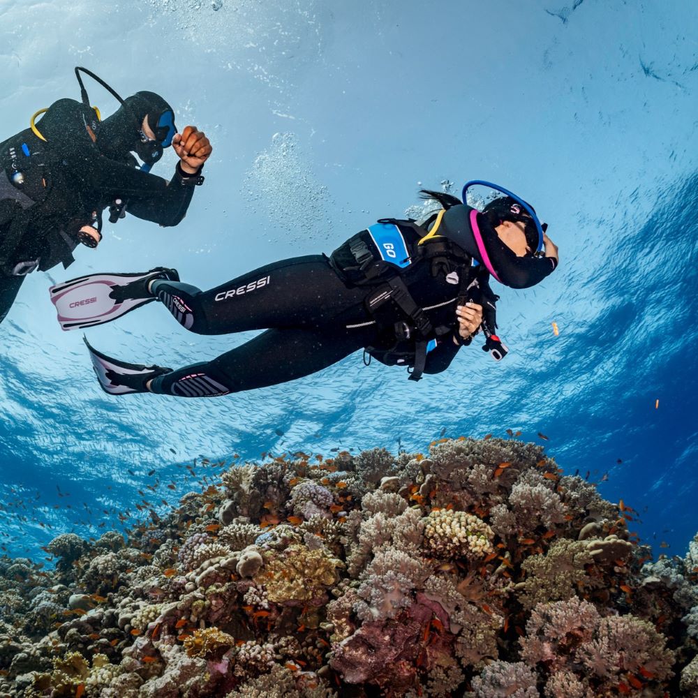 Supportive instructor helping a new diver relax