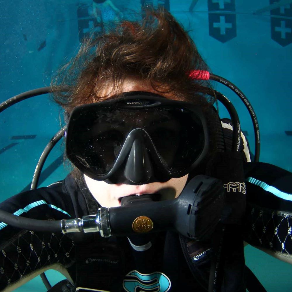 Instructor helping a beginner diver