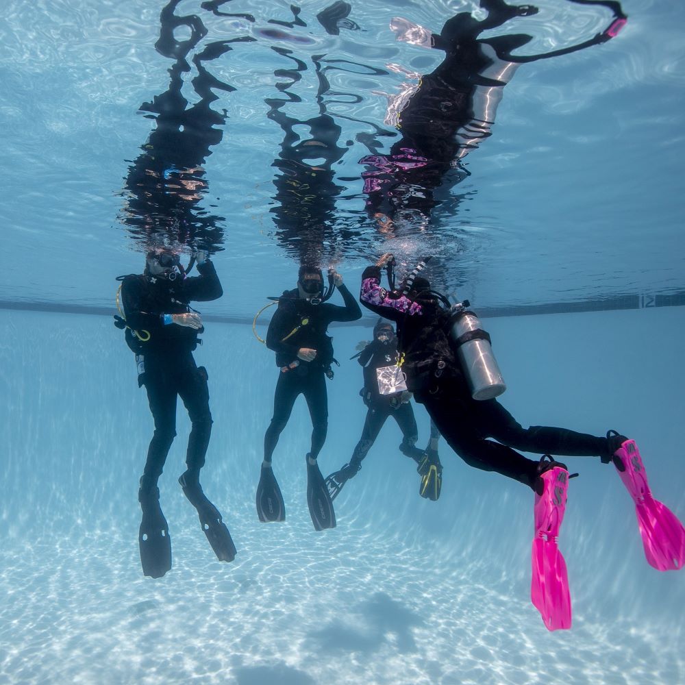 Beginner diver practicing in a pool